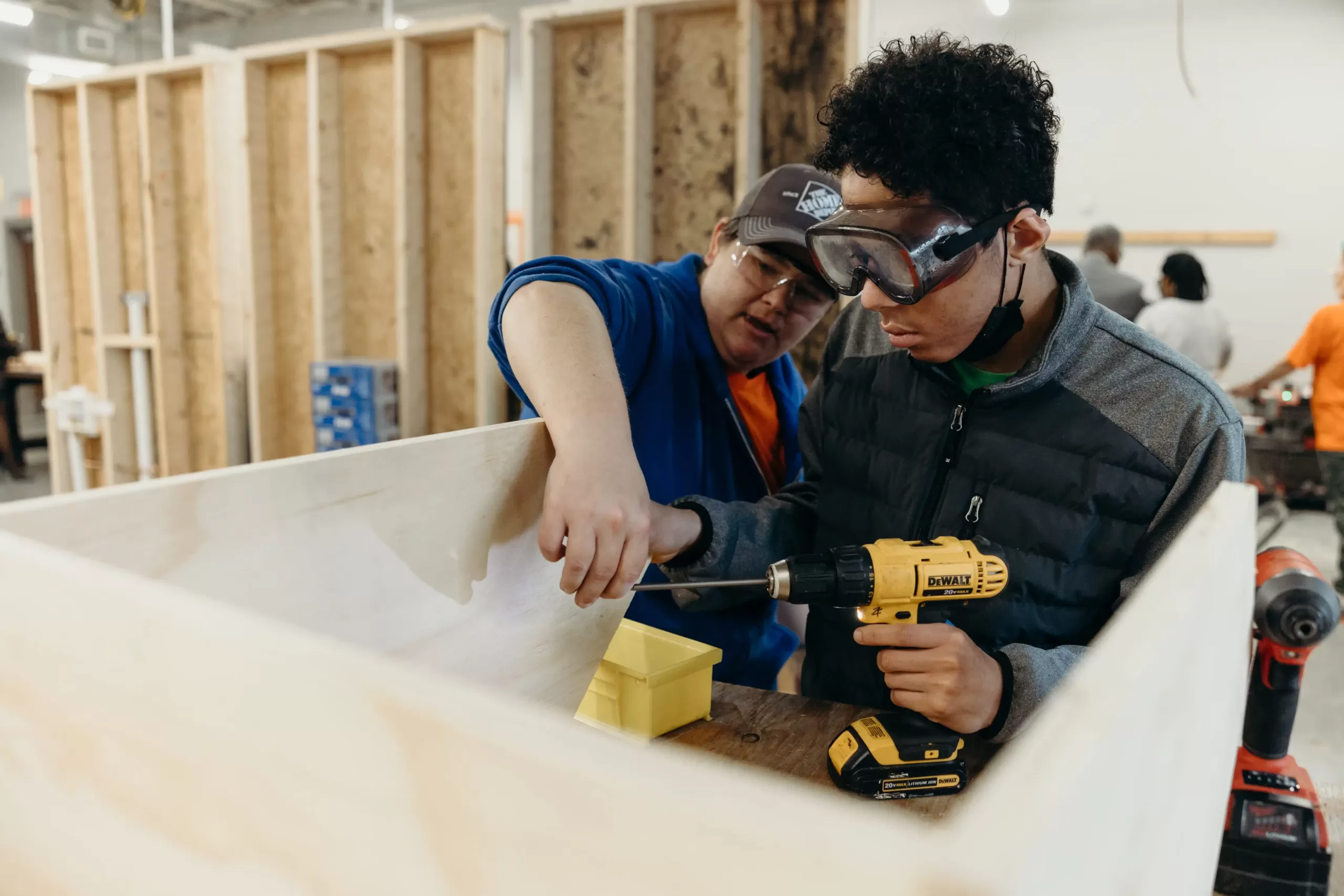 A technical training classroom featuring a student learning to drill